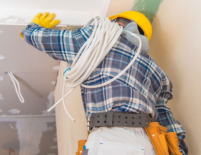 A licensed electrician carrying wiring on a job site, who has a hands-on career at Great Lakes Electric in Northern Ohio.